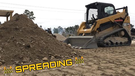 spreading gravel with a skid steer|skid steer for stone.